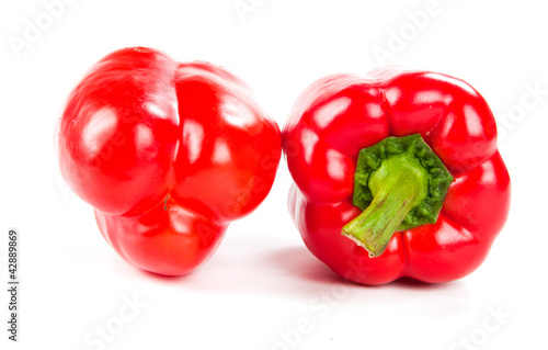 two fresh red peppers on white © Valeri Luzina
