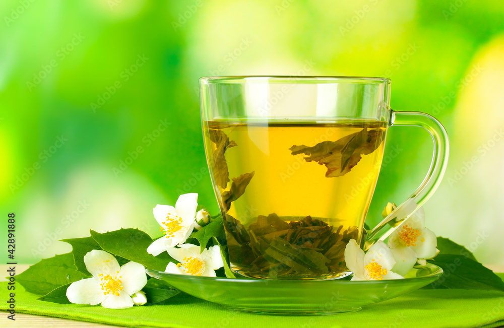 cup of green tea with jasmine flowers cup of green tea with jasmine flowers