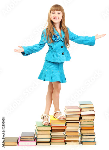 little girl with a books is...