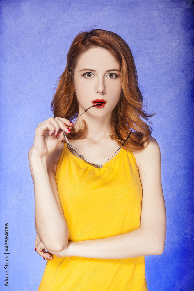 Fototapeta premium American redhead girl in sunglasses. Photo in 60s style.