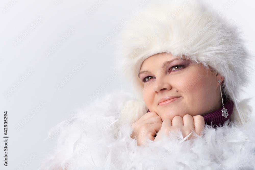 Plump woman among white feathers and fur