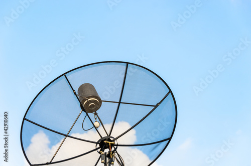 isolate black satellite dish in clear blue sky
