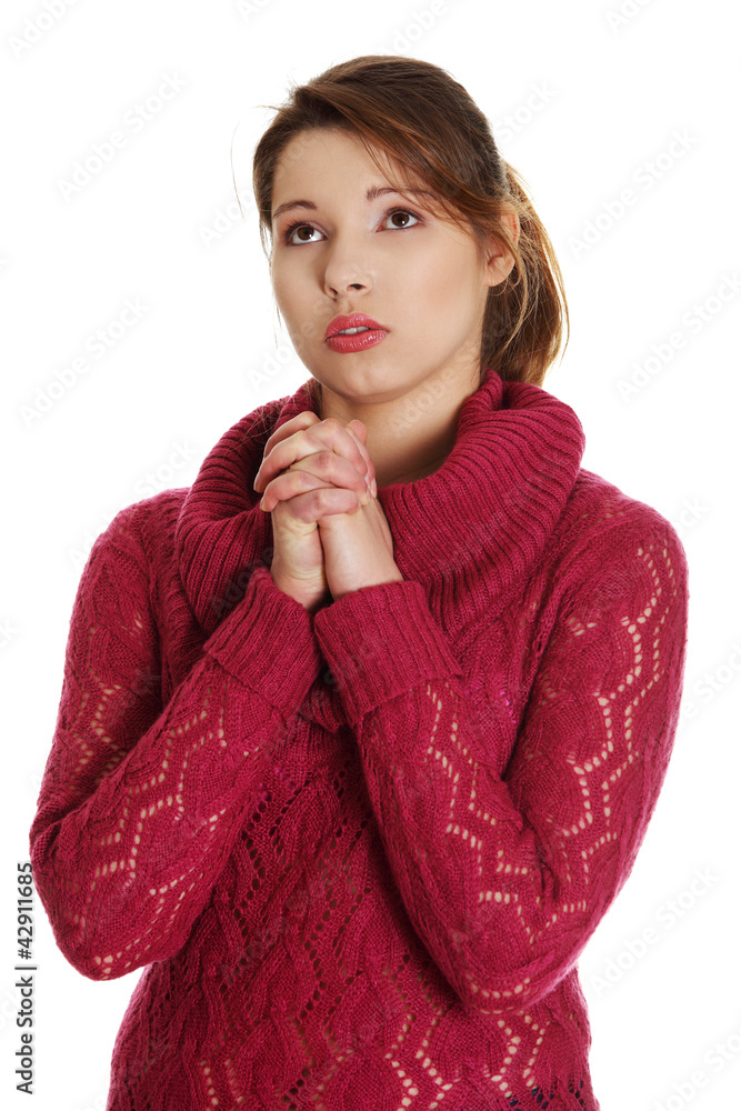 © Piotr Marcinski - Closeup portrait of a young caucasian woman praying
