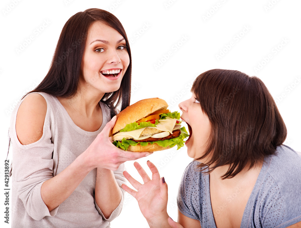 Women eating hamburger.