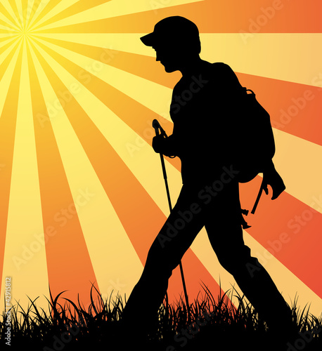 Hiker (backpacker) silhouette walking until sunset.