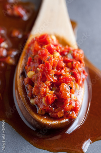 Spoon full of minced chili pepper in oil, calabrian specialty photo