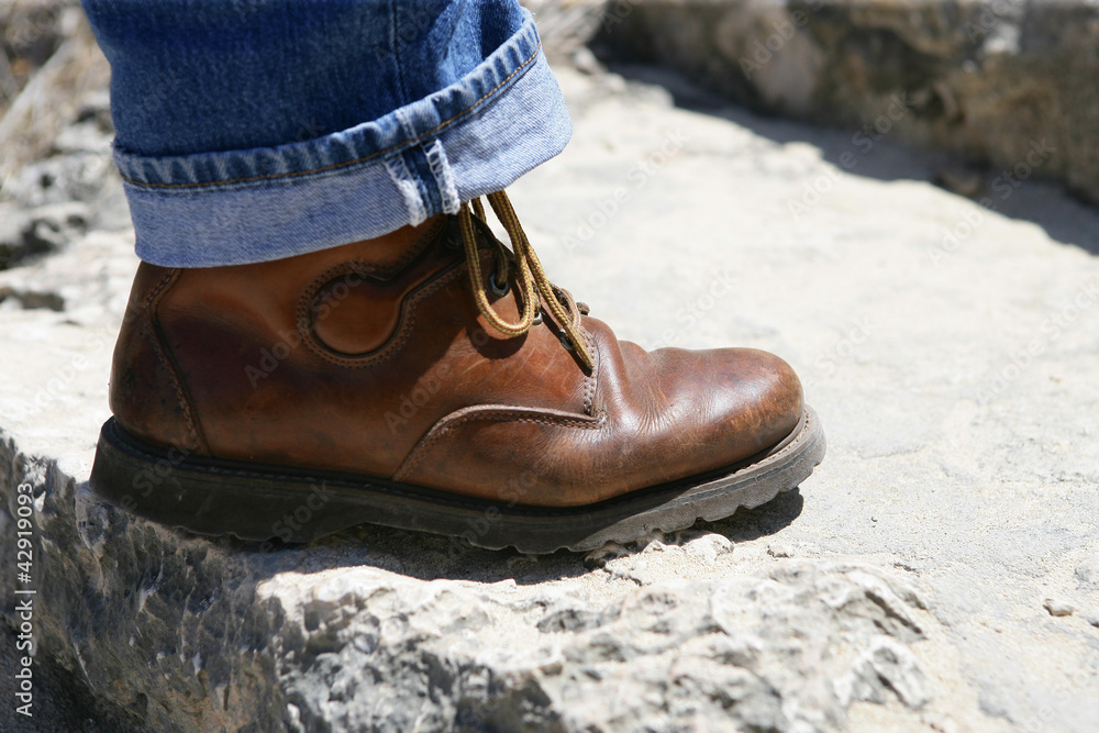 Man's boot on stone