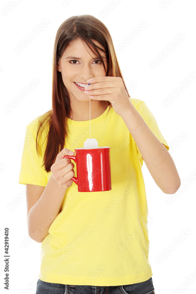 Young beautiful girl is preparing cup of tea. Young beautiful girl is preparing cup of tea.