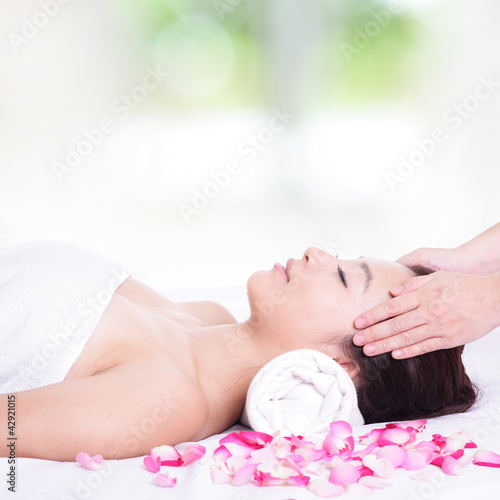 woman enjoy face and head massage at spa