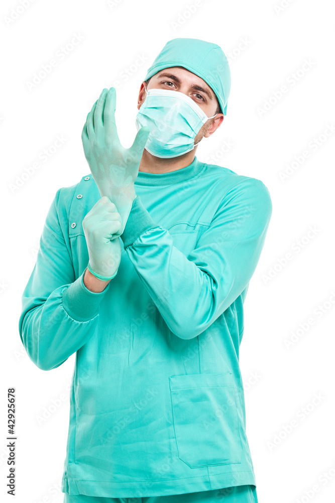 Surgeon wearing a pair of gloves isolated on white Surgeon wearing a pair of gloves isolated on white