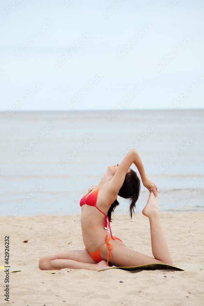 Athletic young woman is training exercises on the beach. Athletic young woman is training exercises on the beach.