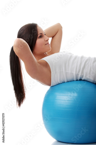 Young woman doing fitness and exercise with ball