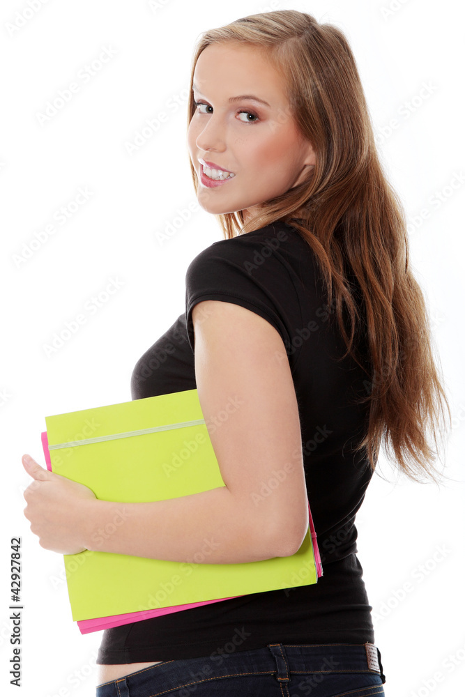 Student girl is holding files and looking back side. Student girl is holding files and looking back side.
