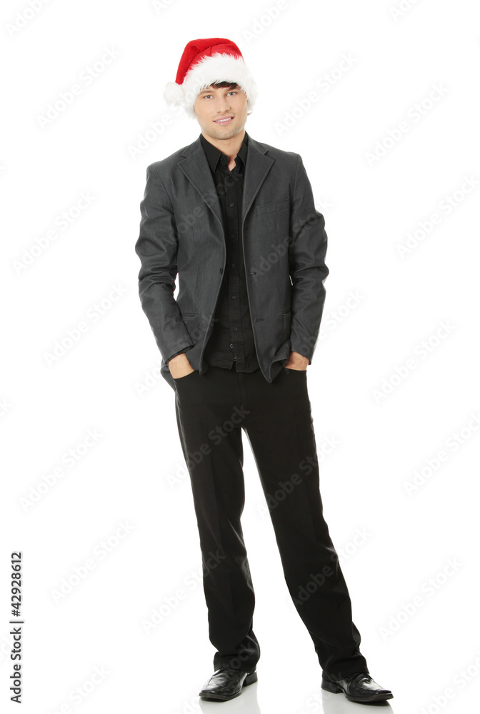 Young man wearing suit and the Santa Claus hat. Young man wearing suit and the Santa Claus hat.