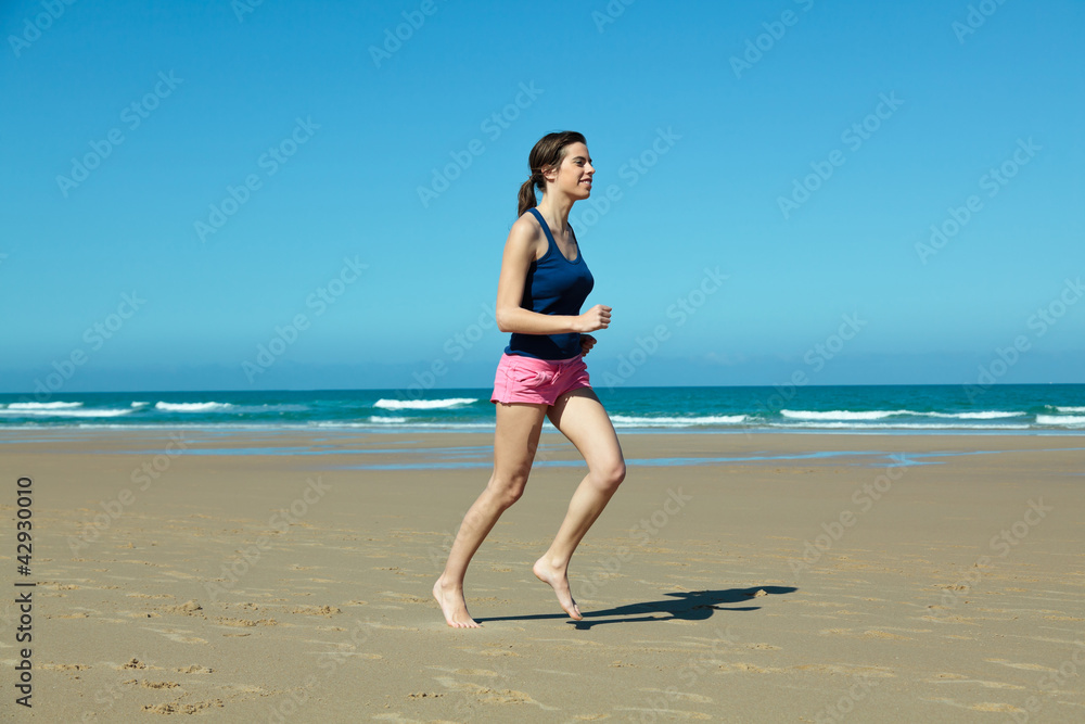 Girl running on the beach in barefoot