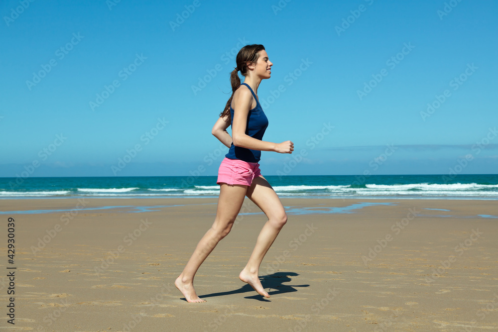 Girl running on the beach in barefoot