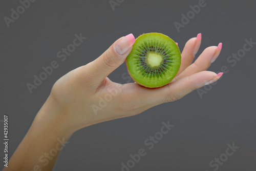 Hand holding kiwi