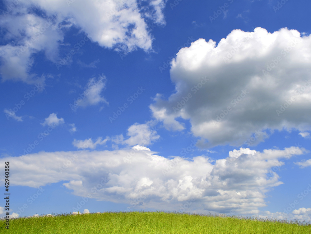 Summer landscape clouds green grass hill
