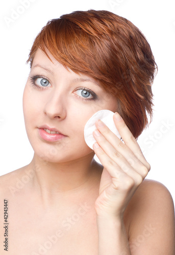 beautiful young female cleaning face skin