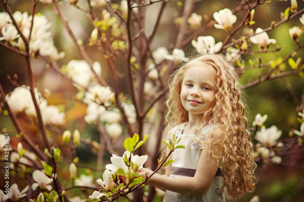 Beautiful girl and blooming magnolia tree Beautiful girl and blooming magnolia tree