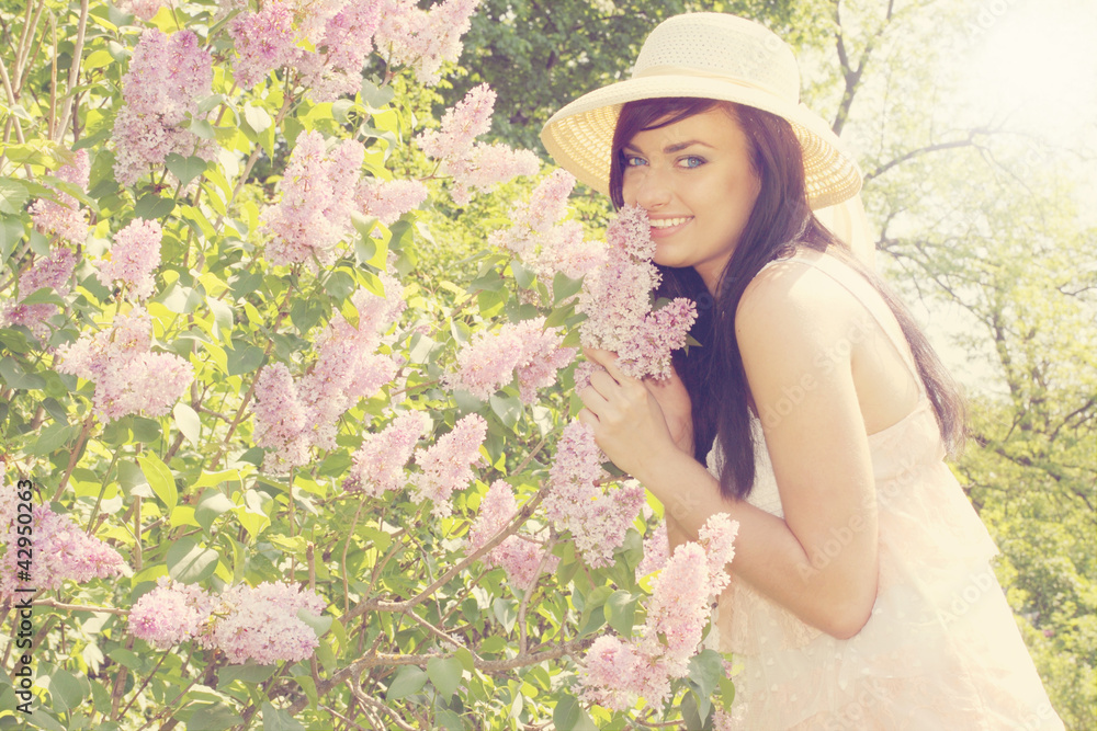 Fototapeta premium woman smelling a lilac