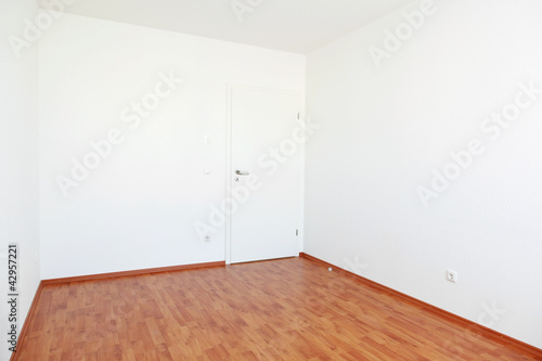 Empty room with white door