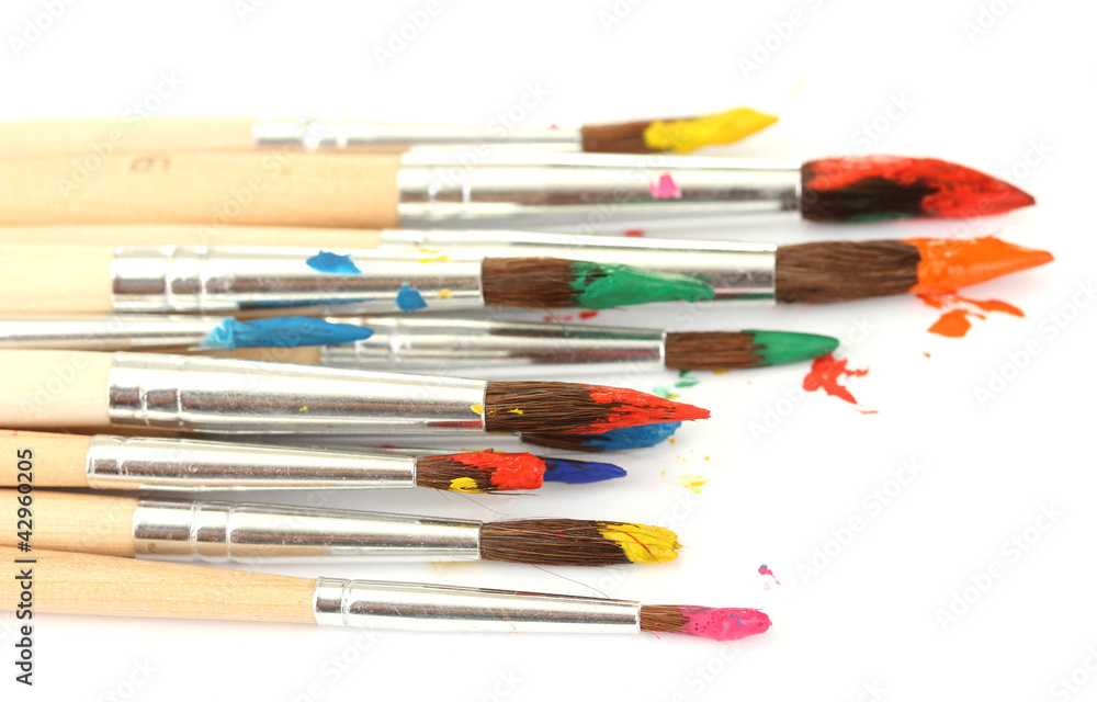 Obraz premium Paint brushes with gouache isolated on white