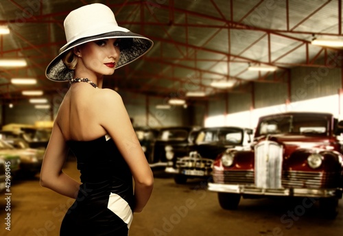 Woman in hat in retro garage © Nejron Photo