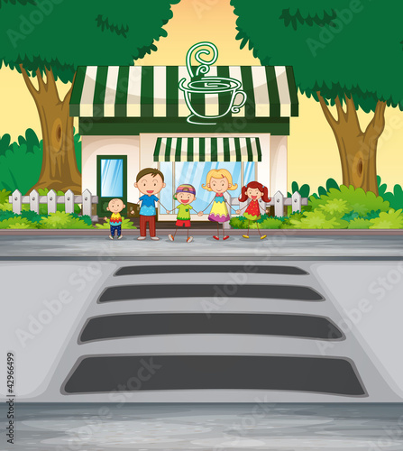 family crossing road near coffee shop