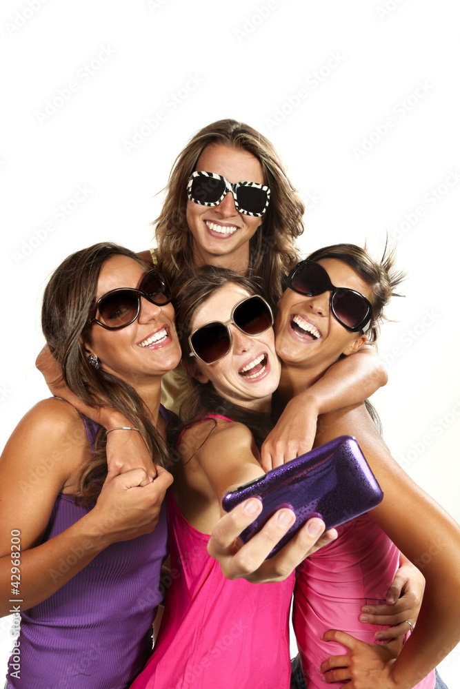Fototapeta premium Happy young girls while taking pictures of themselves