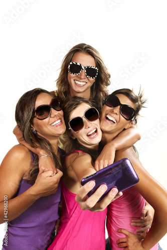 Tableau sur toile Happy young girls while taking pictures of themselves