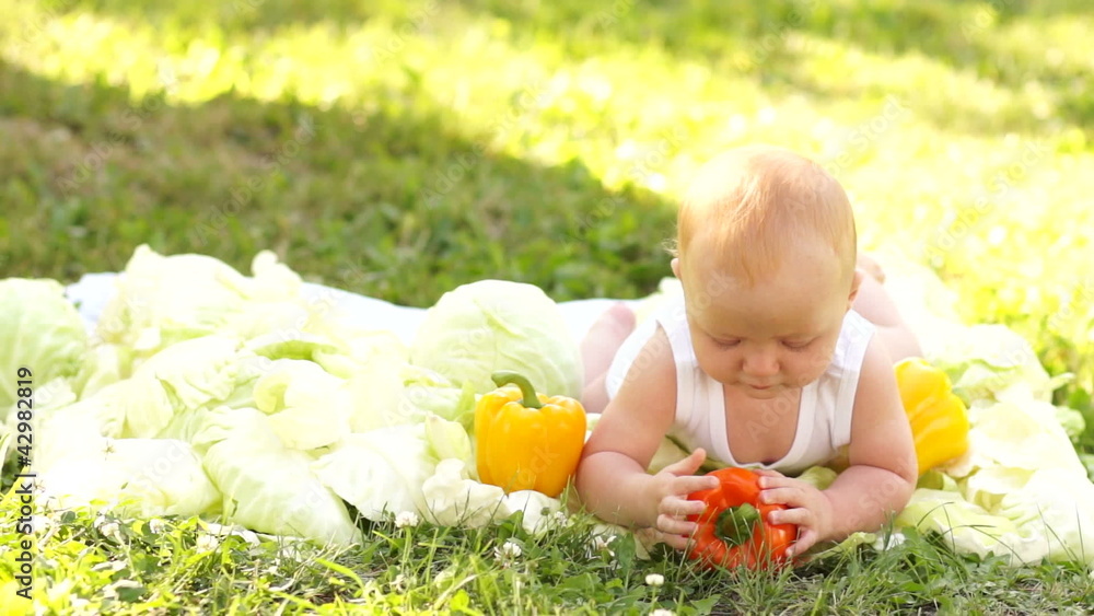 New born trying to walk. Baby in the vegetables