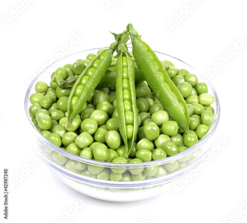 fresh green peas in a bowl  isolated on a white background