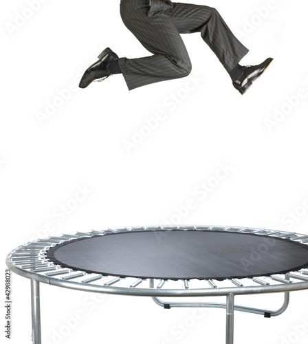 businessman bouncing on a trampoline on white