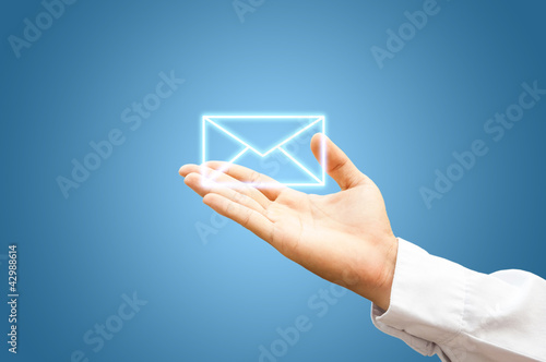 Hand with mail symbol on blue background