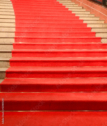 Stairs covered with red carpet