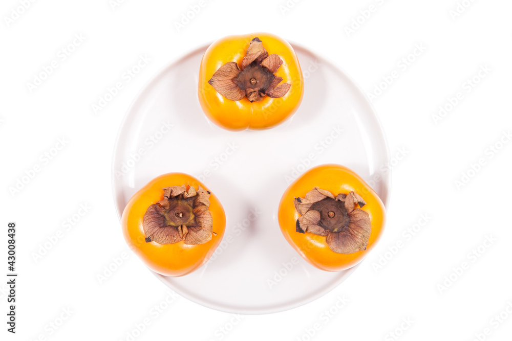 Fresh persimmons isolated on plate Fresh persimmons isolated on plate
