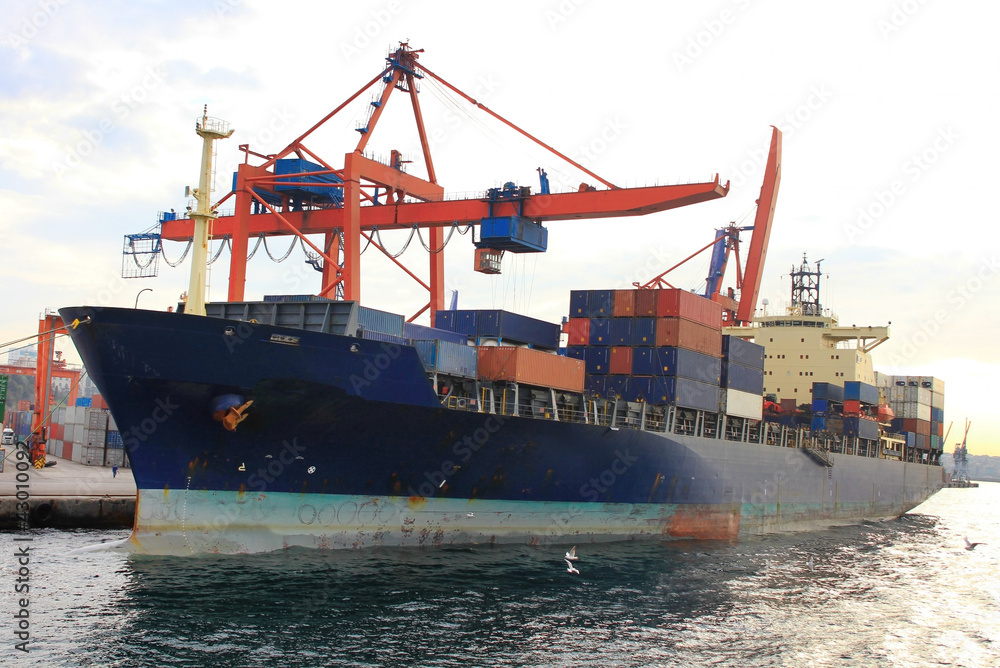 Cargo container ship under quayside crane