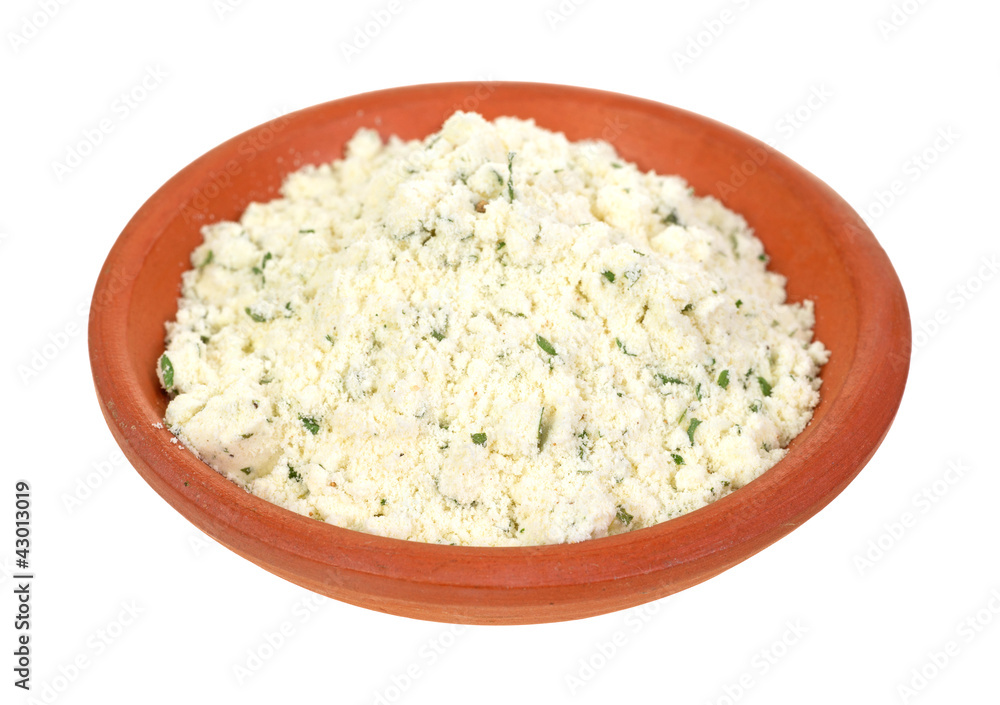 Powdered ricotta cheese with herbs in small bowl Powdered ricotta cheese with herbs in small bowl