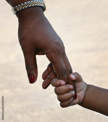 African-American family: child is holding mothers hand