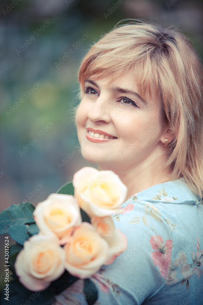 Fototapeta premium Happy smiling woman with flower