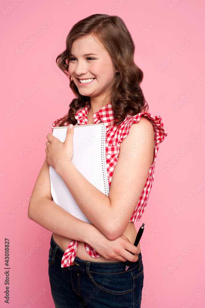 Trendy young girl posing with spiral notepad Trendy young girl posing with spiral notepad