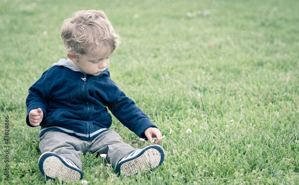One year boy playing in the park portrait. One year boy playing in the park portrait.