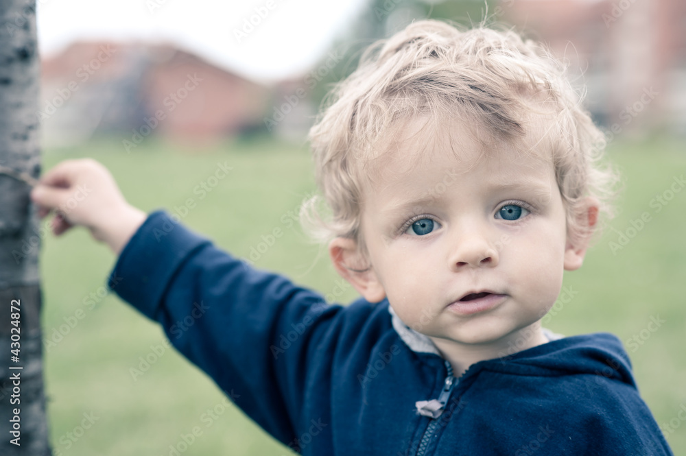 One year boy playing in the park portrait. One year boy playing in the park portrait.