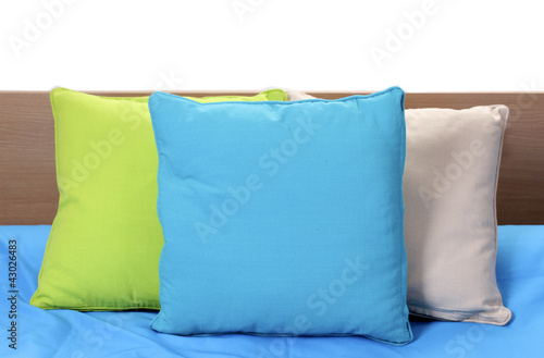 bright pillows on bed on white background