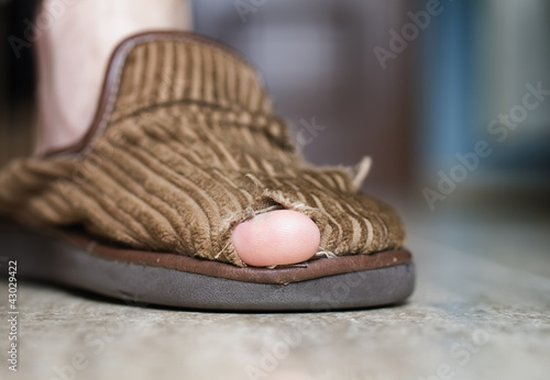 broken slipper with hole and finger