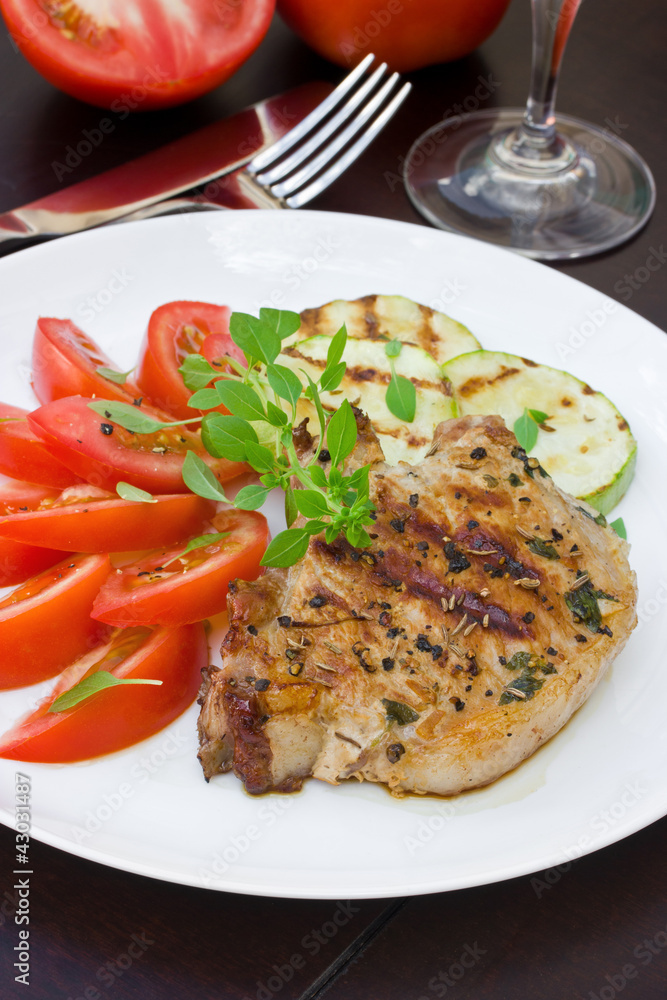 Grilled steak, salad of tomatoes and grilled zucchini