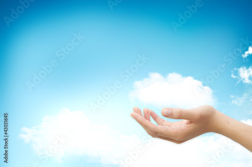 Hand handle cloud against blue sky with clouds on background. Fo