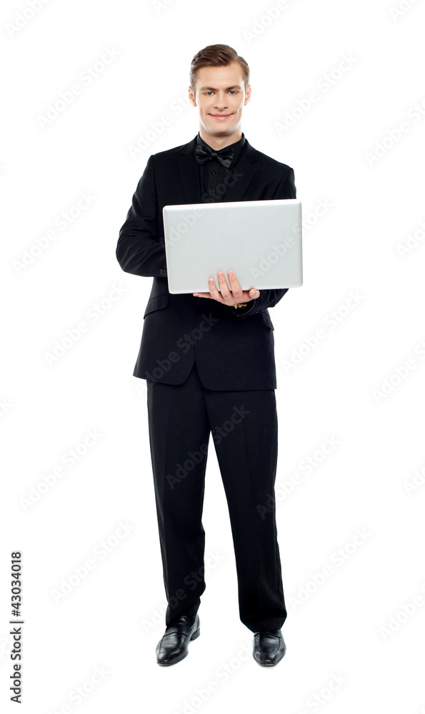 Smiling young man working on laptop Smiling young man working on laptop