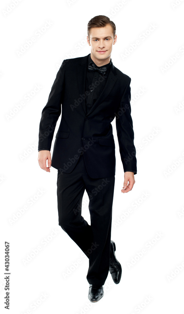Isolated young man standing with crossed legs Isolated young man standing with crossed legs